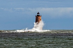 Huge Wave Wraps Around Stone Lighthouse Tower in Maine